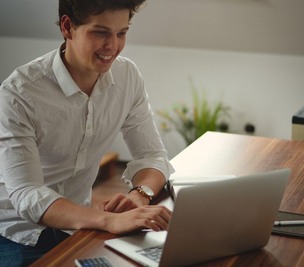 student review something on laptop screen while sitting at a desk
