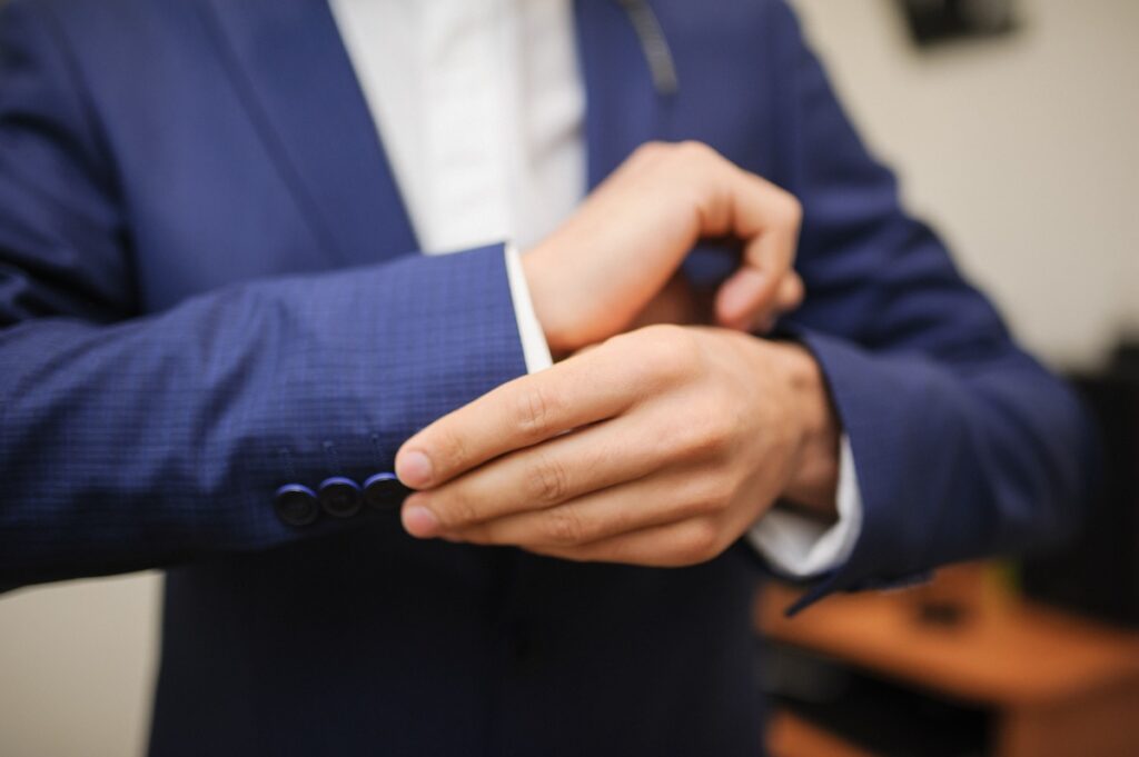 A man fastening a cuff link
