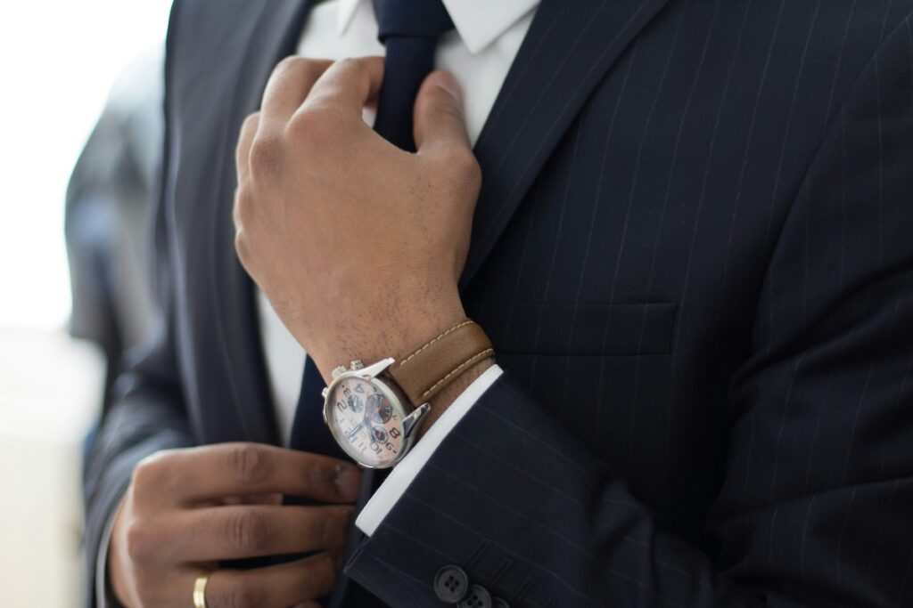 man in a suit adjusting his tie