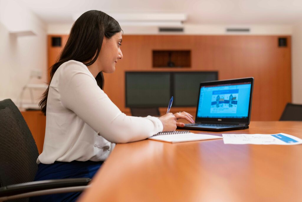 woman studies at laptop on a desk