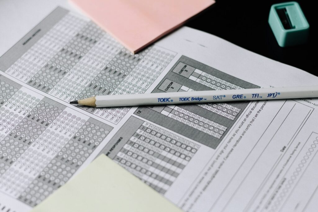 multiple choice bubble sheets for GRE test on table with pencil on top
