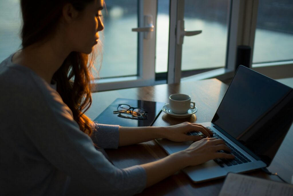 woman studies for test on laptop