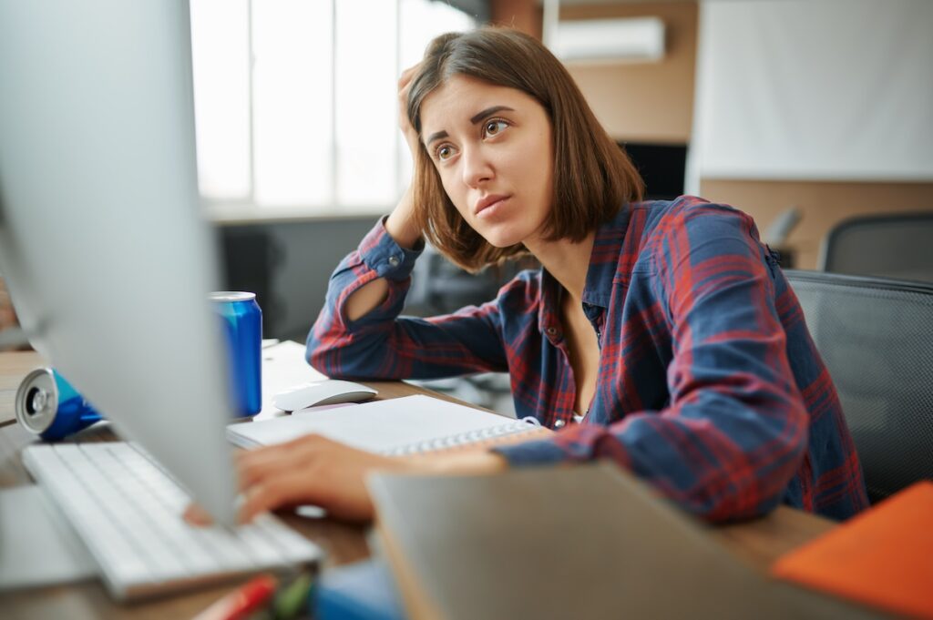 tired student works on computer