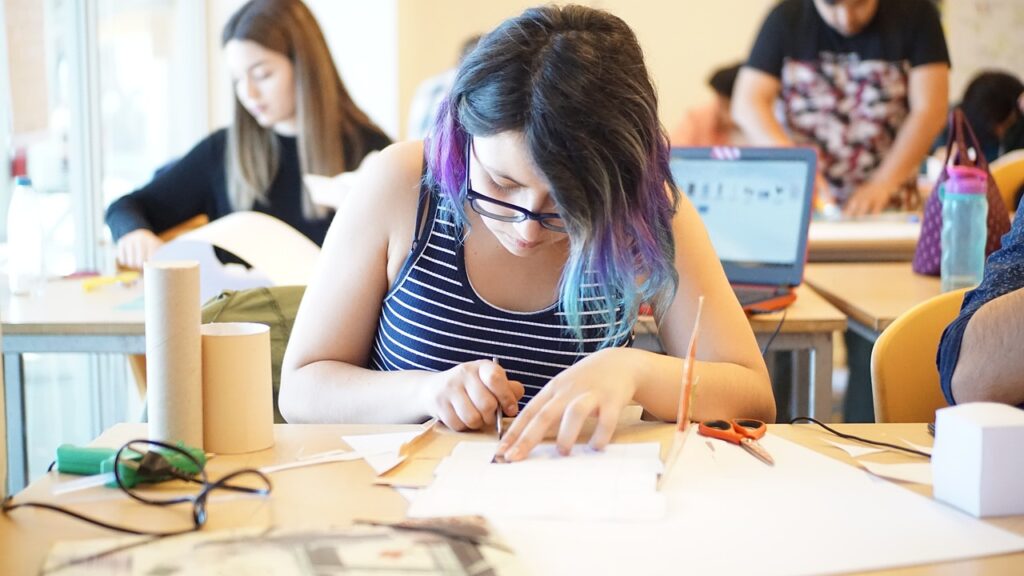 students hunched over desks, studying