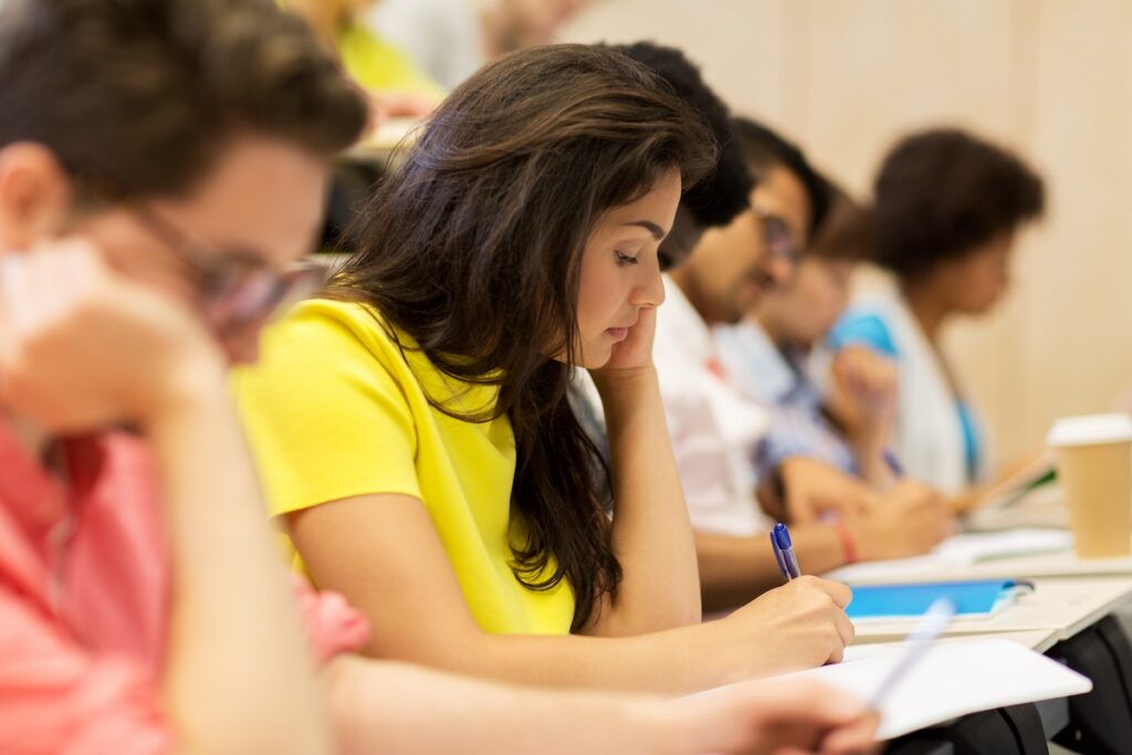 group of students in desks taking a test