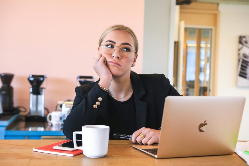 woman working at lapto looking pensive