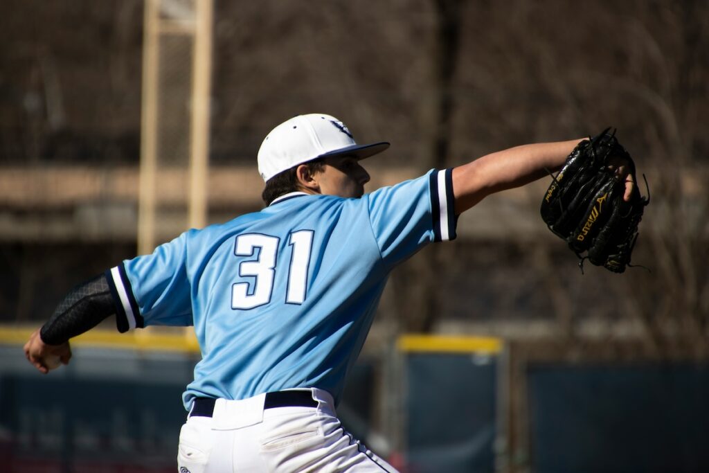 male baseball player throws ball