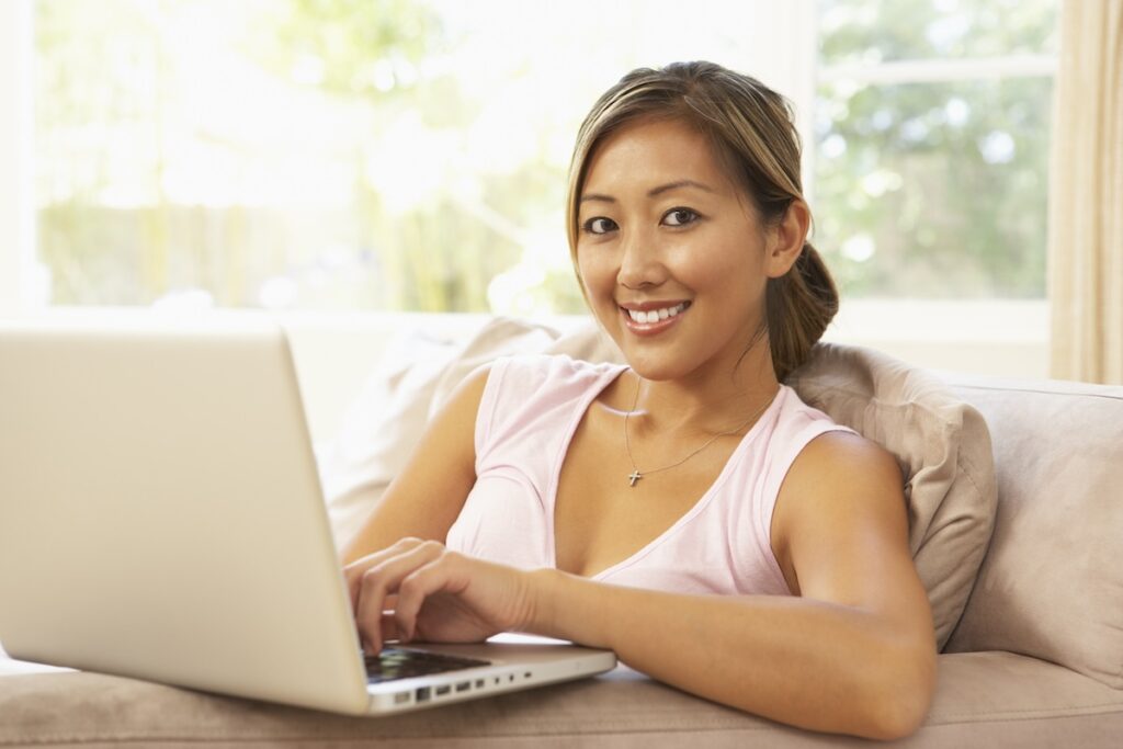 Young Woman Using Laptop At Home