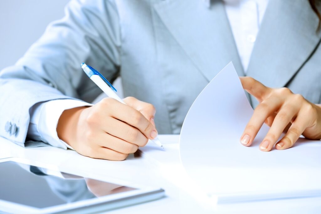 professional person reviews papers and marks them with a pen