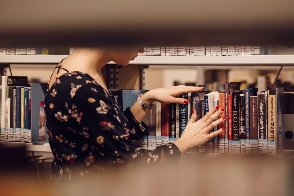 student captured through the stacks, looking for a library book