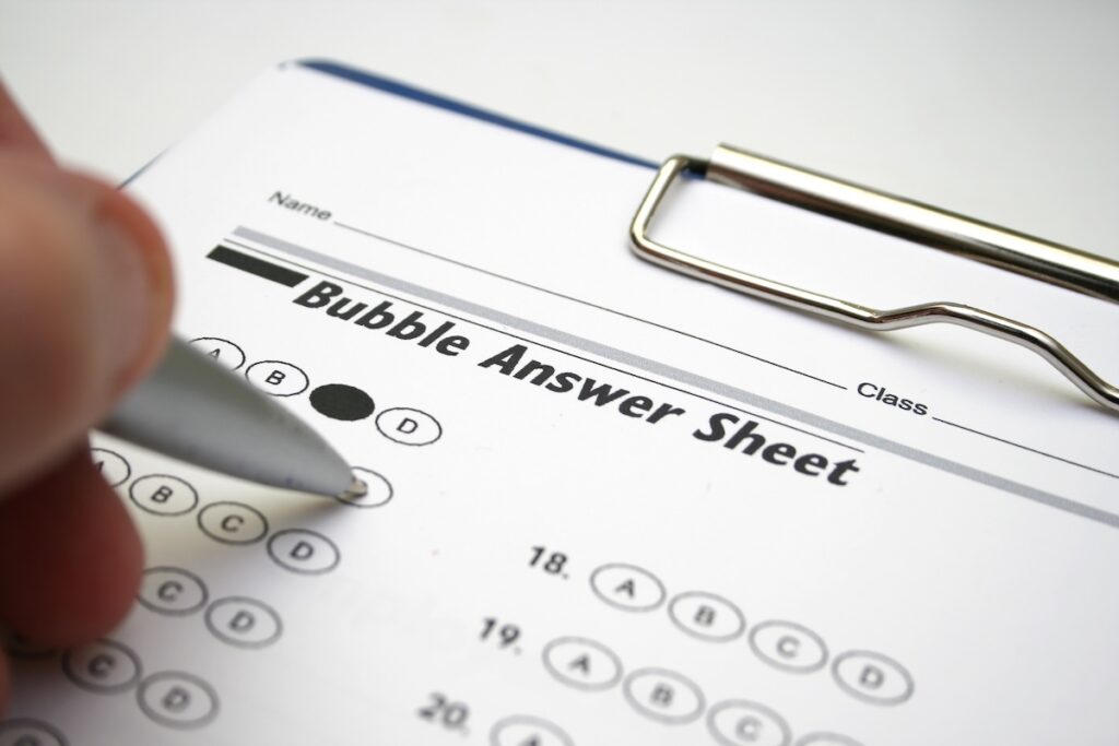 filling in paper test answer sheet