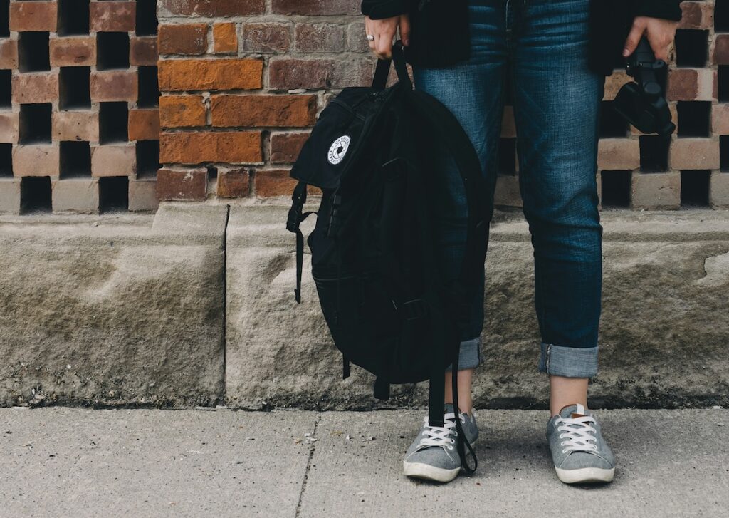 student holding backpack