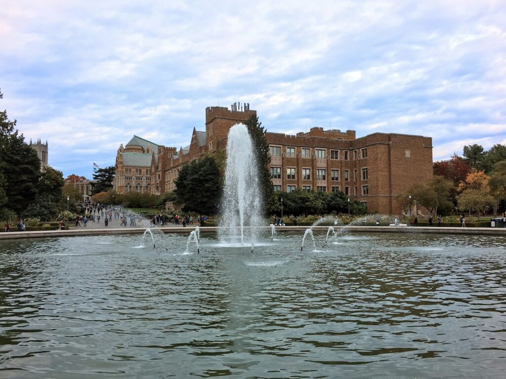 exterior of university of washington building seen from across a large fountain