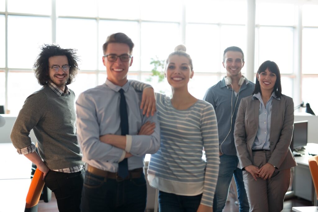 Portrait of young business people discussing business plan in the office