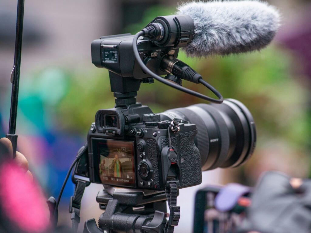 looking at a news camera from behind the lens