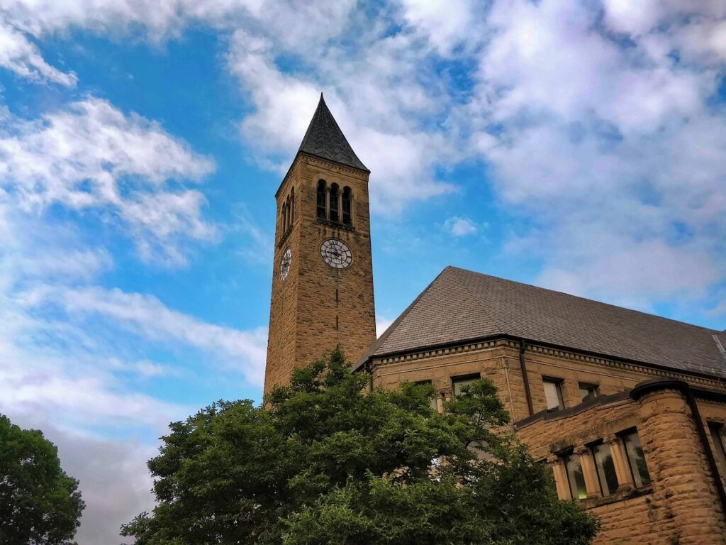 looking up at the clocktower on a brick building at Cornell University