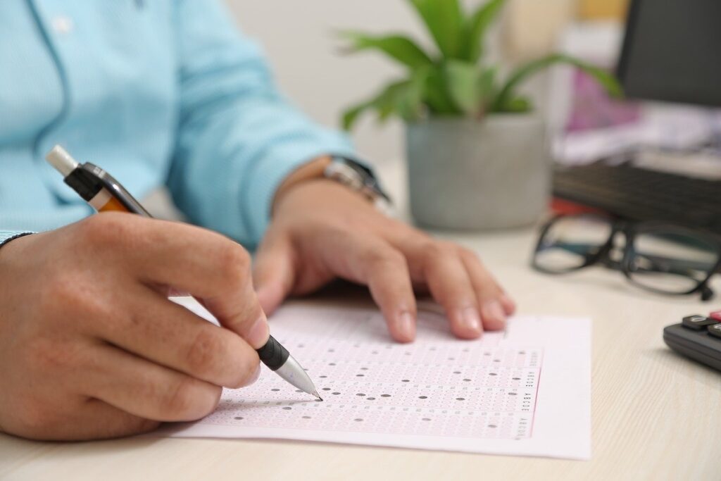 person fills out test paper