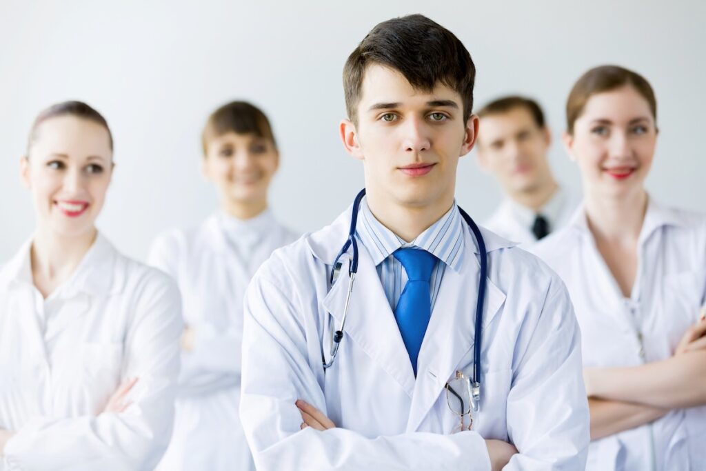 group of young doctors standing in hospital corridor