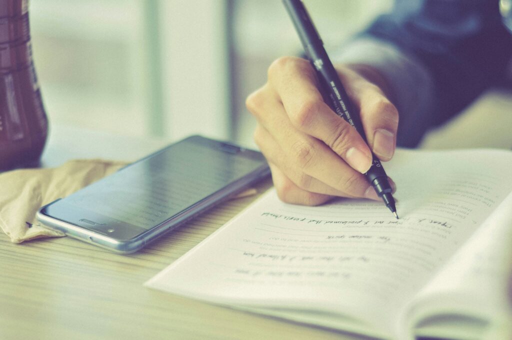 person writes in test booklet
