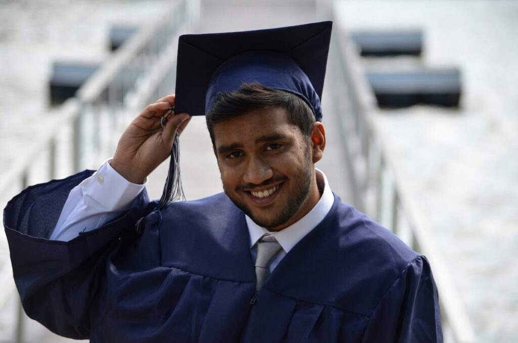 male graduate in cap and gown