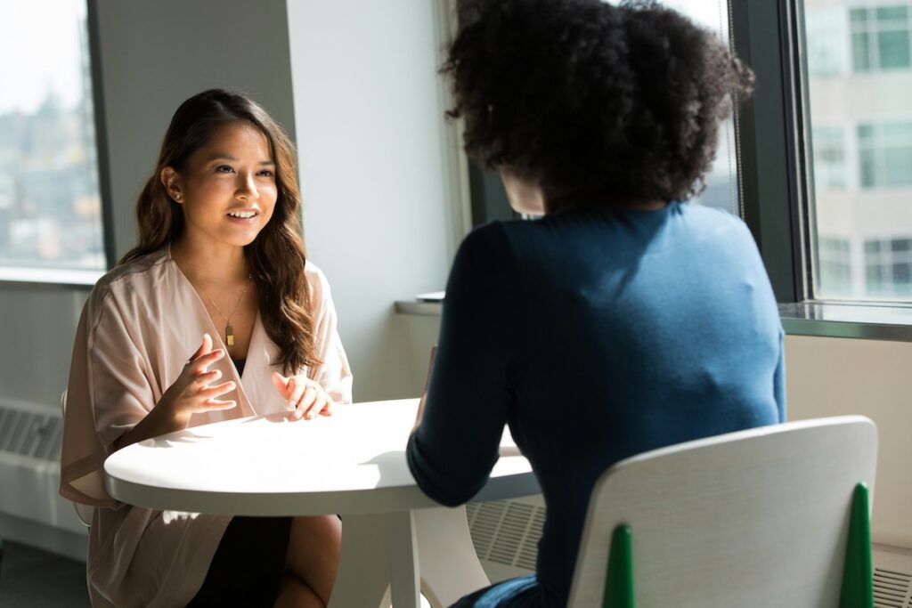 woman interviews another woman in a corporate setting