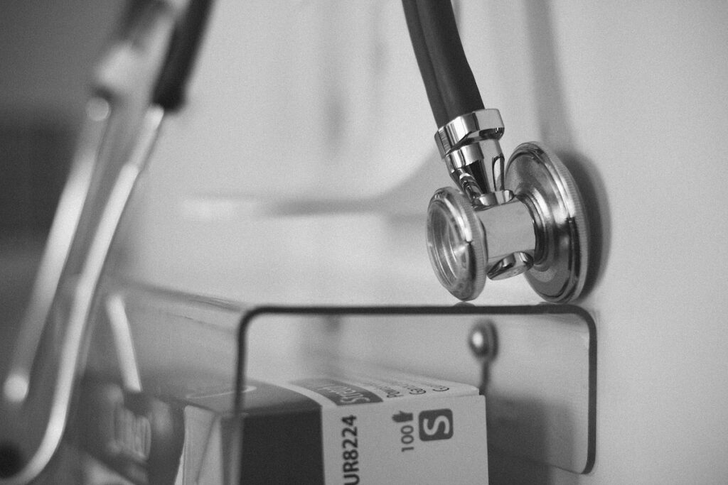 stethoscope and ID card in a plastic bin