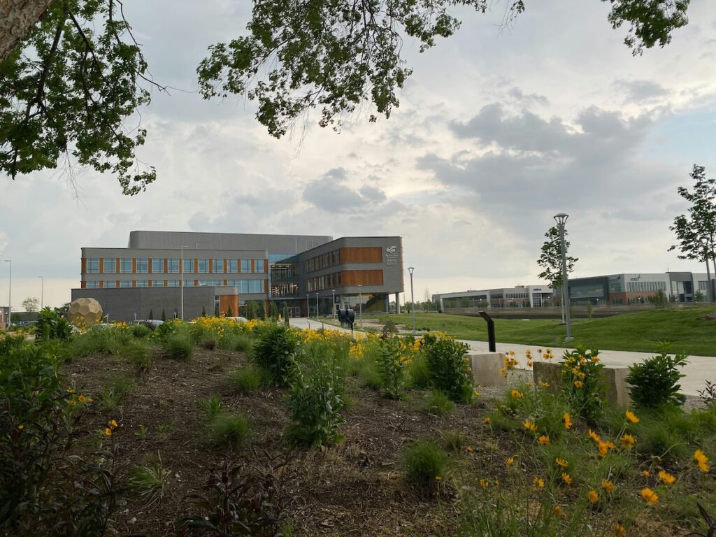 university building with green garden in front