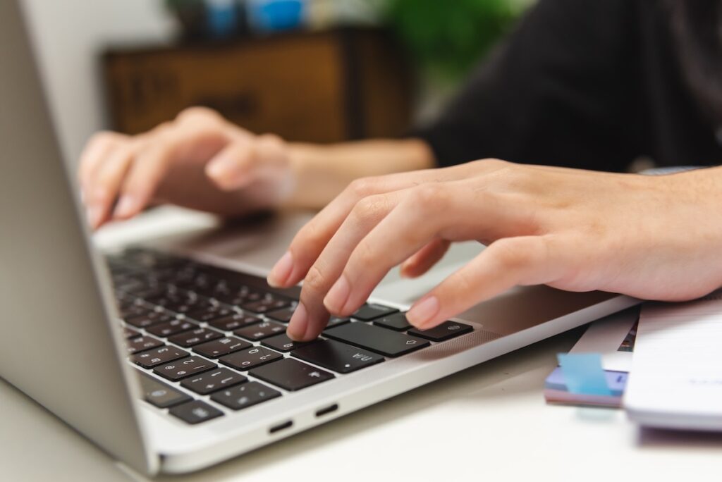 woman typing on laptop
