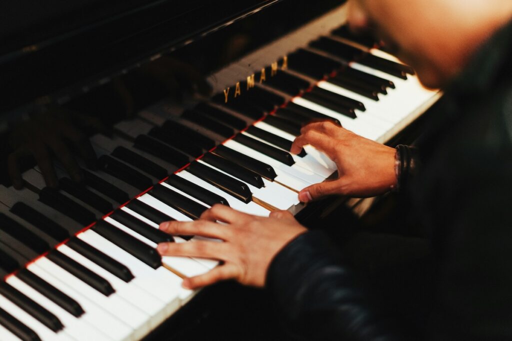 close up of hands playing piano