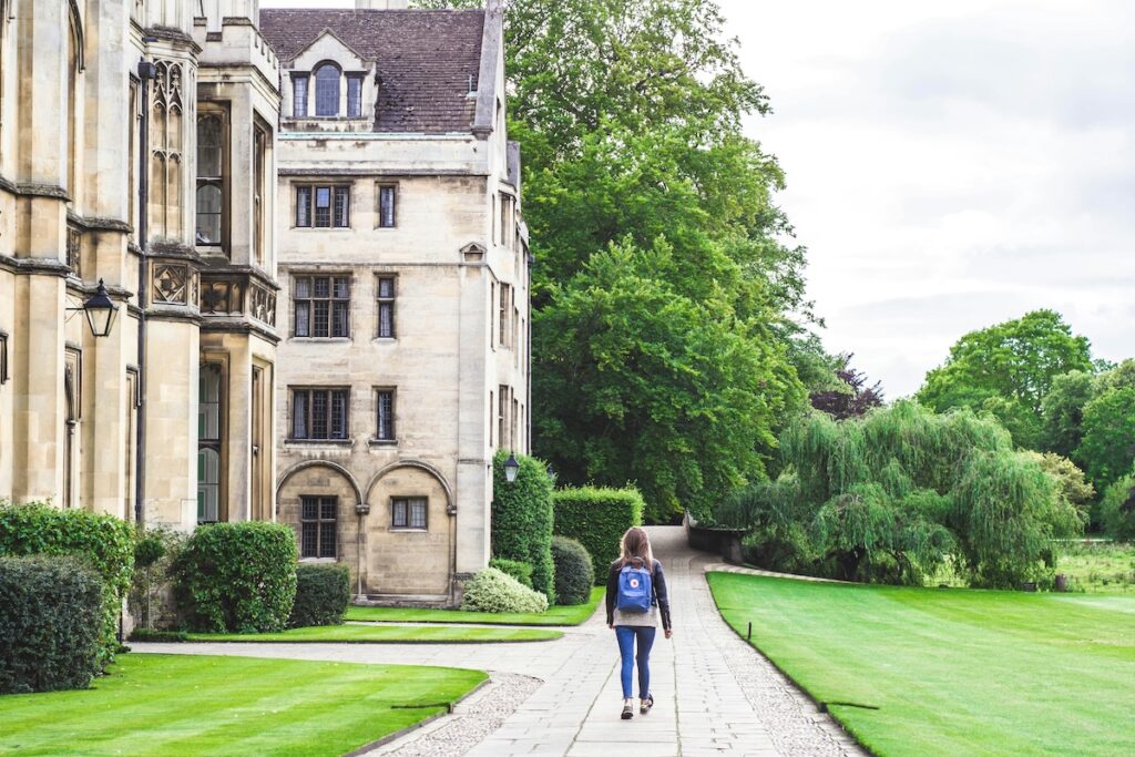 exterior of Oxford University with student walking by
