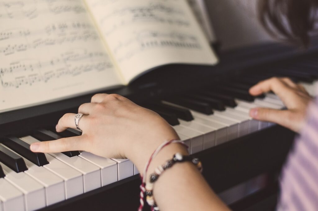 close up of a woman's hands playing piano