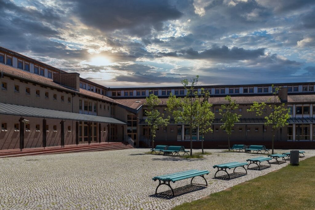 empty high school courtyard with two benches