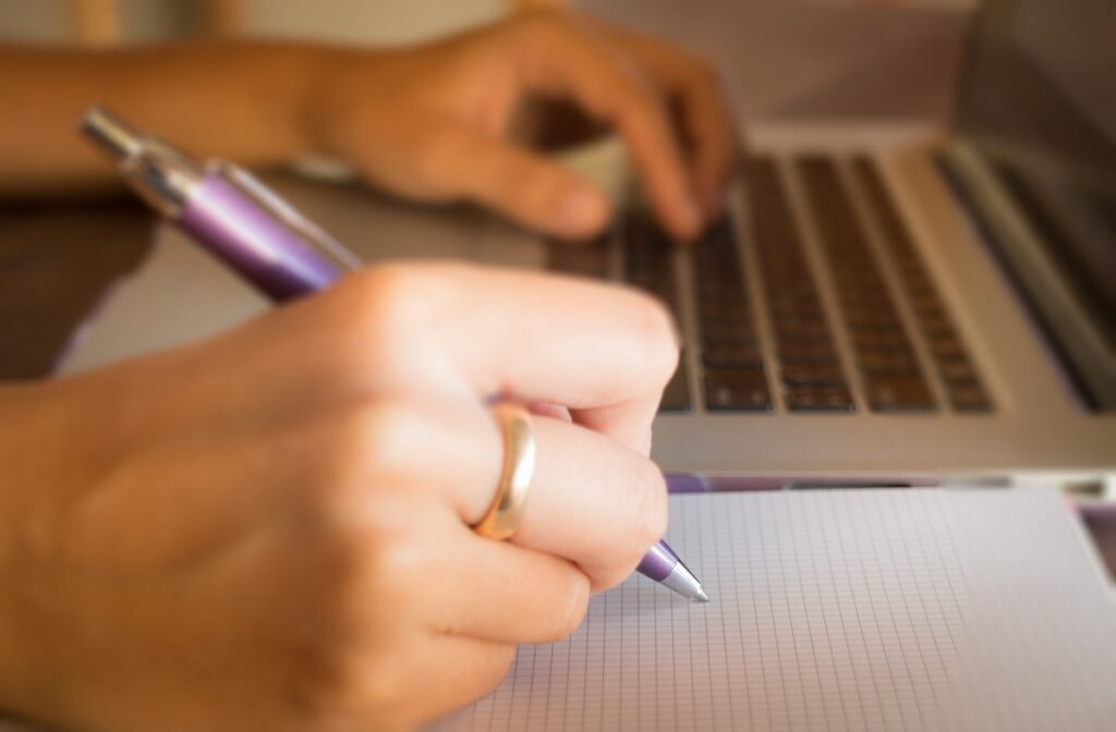 Opened laptop on wooden work table, stock photo