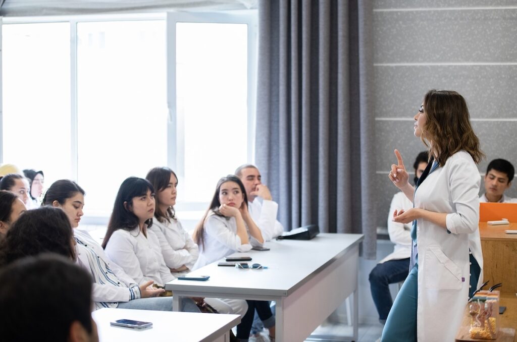 doctor addresses a classroom of medical students