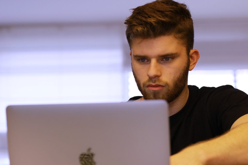 male student works on laptop