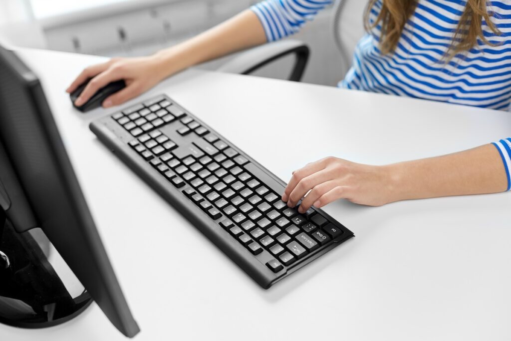close up of woman working on computer at home