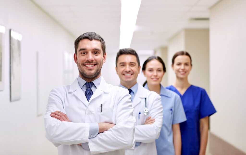 group of happy medics or doctors at hospital