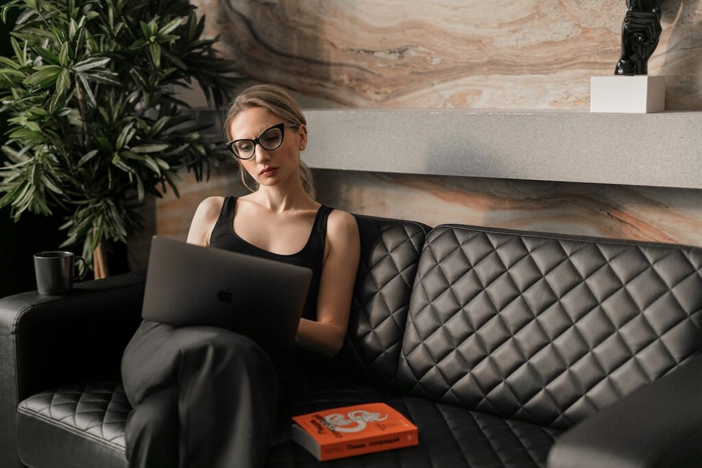 woman in professional setting works on laptop