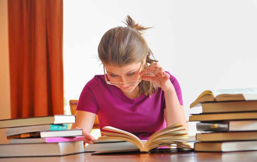high school student studies a textbook