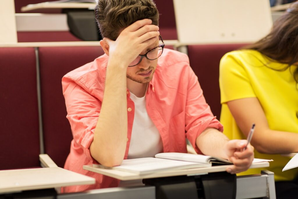 group of students with notebooks in lecture hall