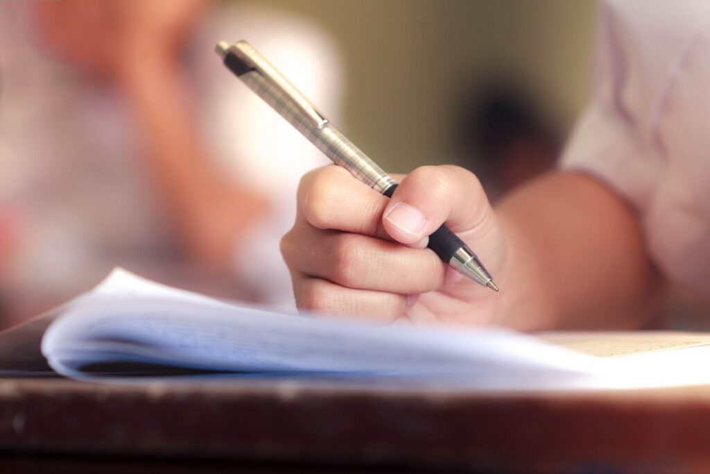student filling out test paper