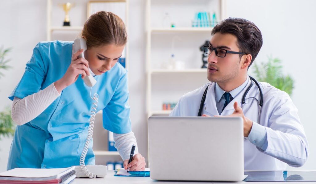 Male and female doctor having discussion in hospital