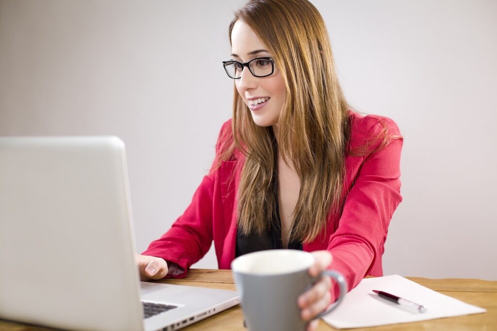 young woman works on laptop computer
