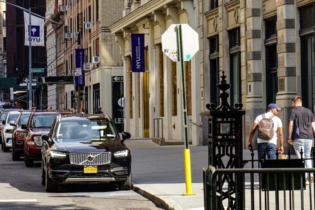 New York City street with buildings displaying NYU banners