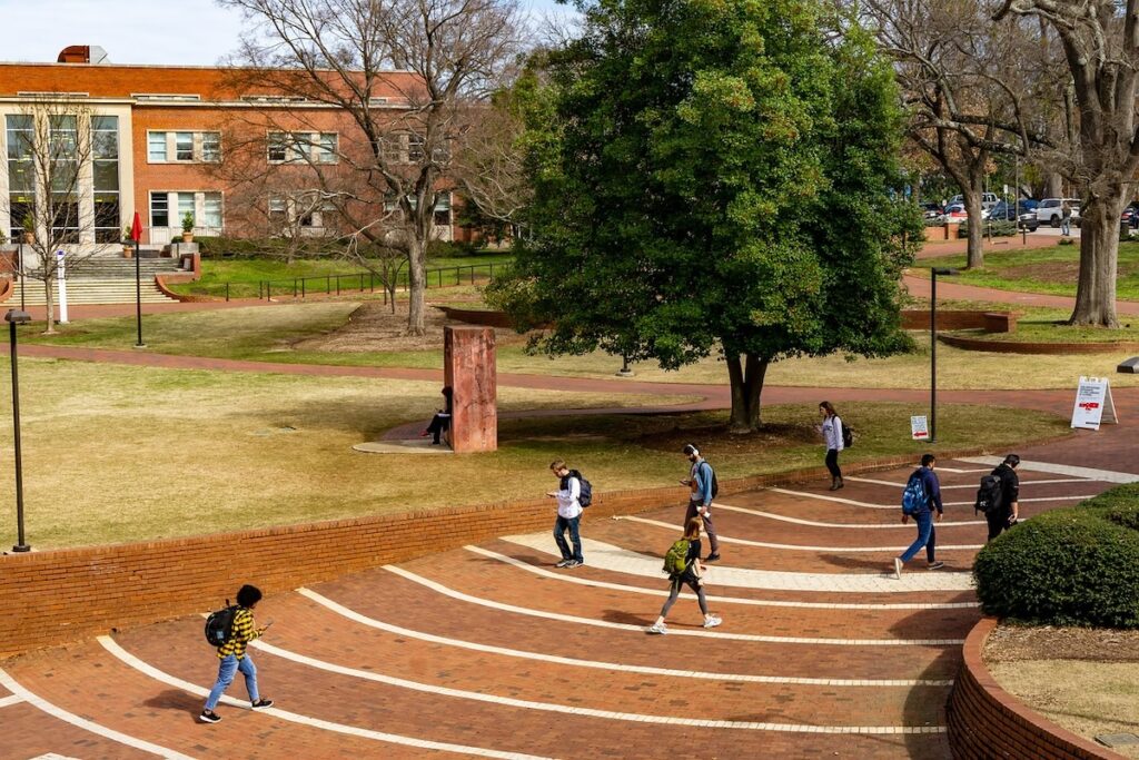students walk to class on university campus