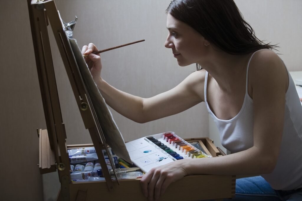 artist painting on easel