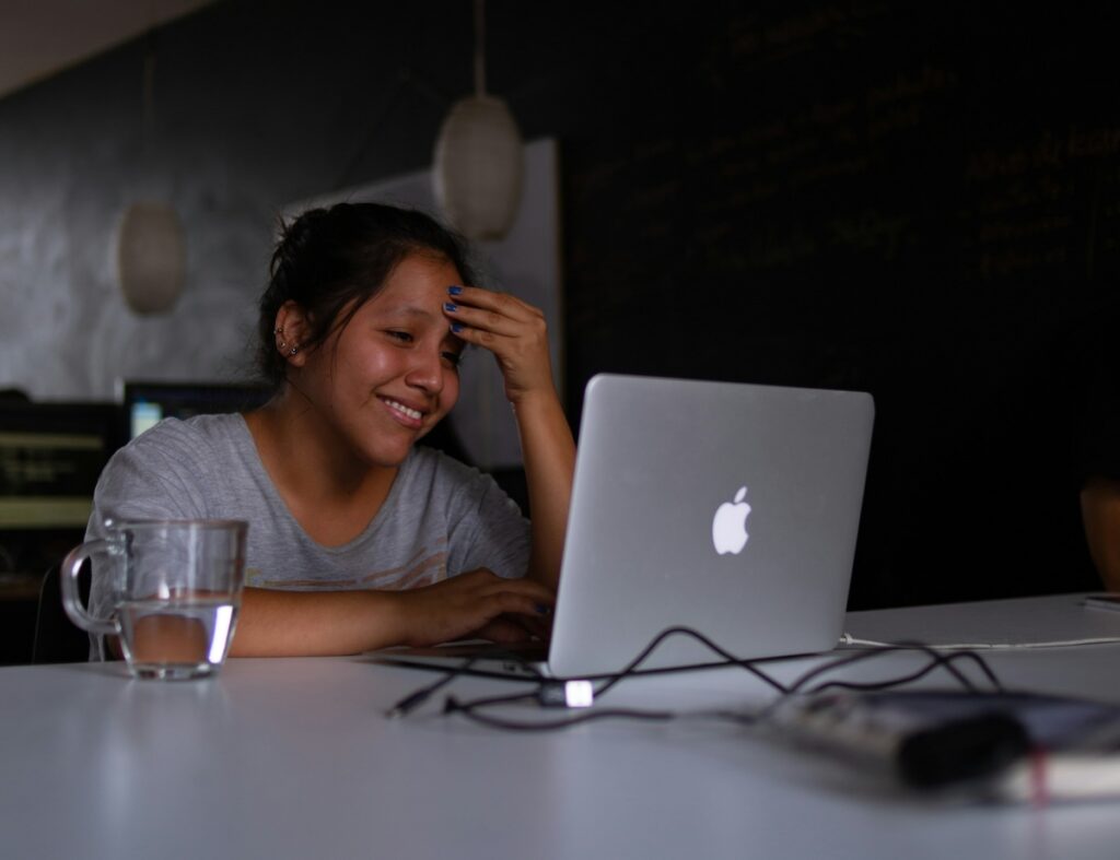 student works at her laptop