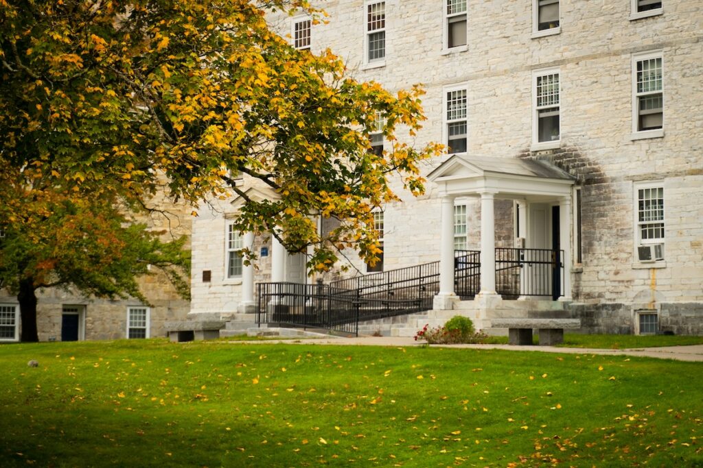 exterior of collegiate building with tree in foreground