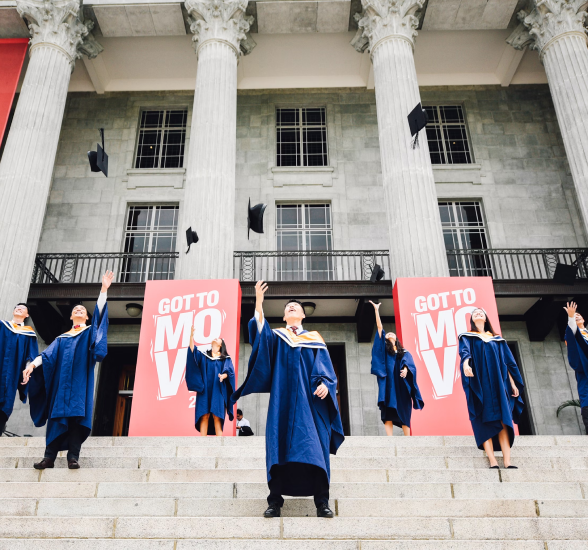 students in robes are celebrating