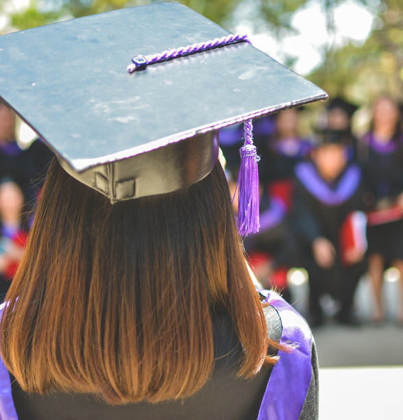 Happy Female Student In Graduation Robe